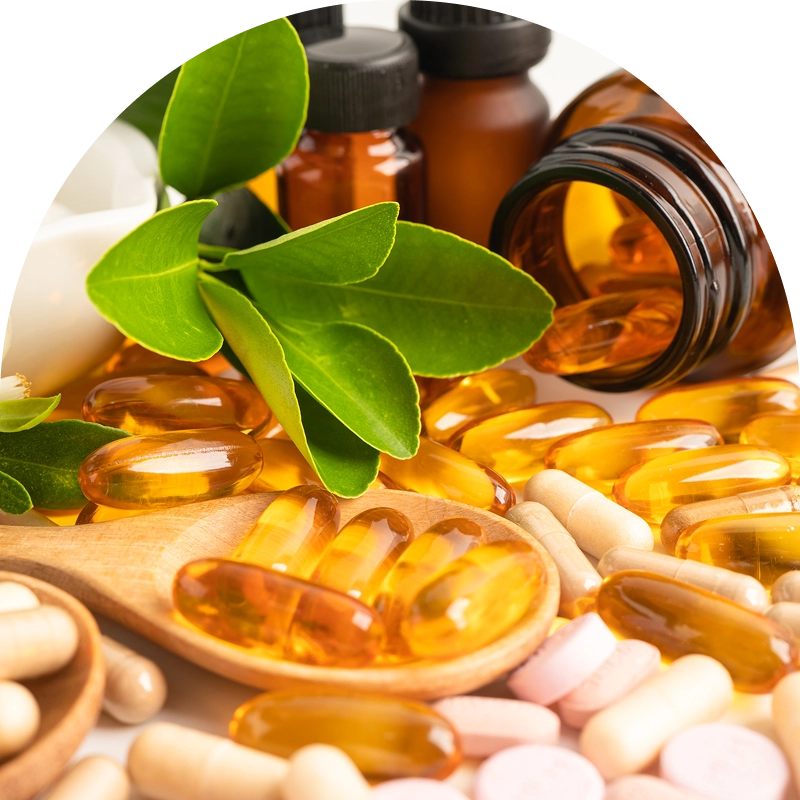Vitamins and supplements with green leaves displayed. Vitamins and supplements with green leaves displayed.